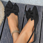 Ladies elegant lace ballerinas with large decorative bow and shimmering upper material