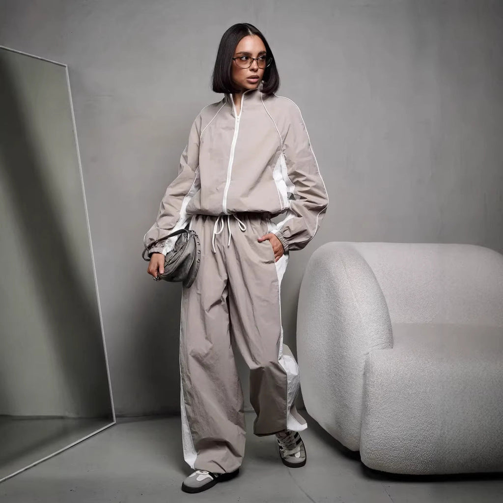 Women's sporty-elegant track set with stand-up collar, zip jacket, and wide side stripe trousers
