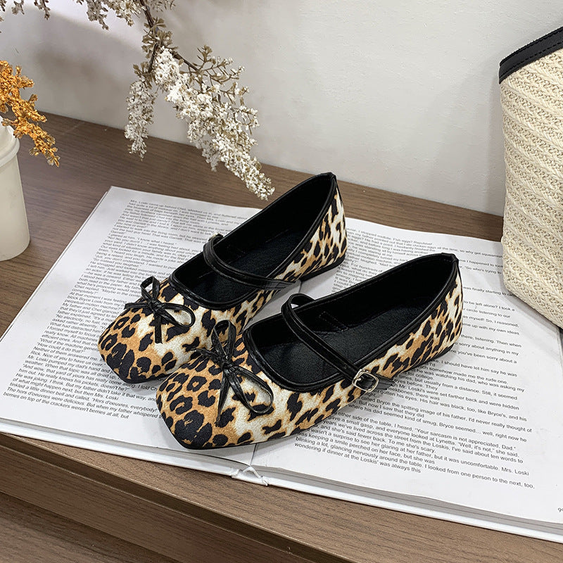 Women's ballet flats with decorative bow accent and comfortable adjustable strap