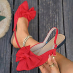 Ladies elegant lace ballerinas with large decorative bow and shimmering upper material