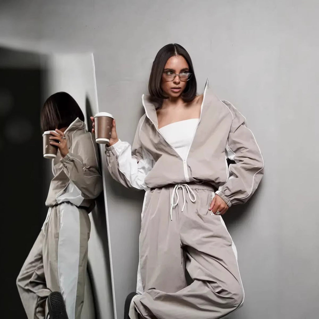Women's sporty-elegant track set with stand-up collar, zip jacket, and wide side stripe trousers