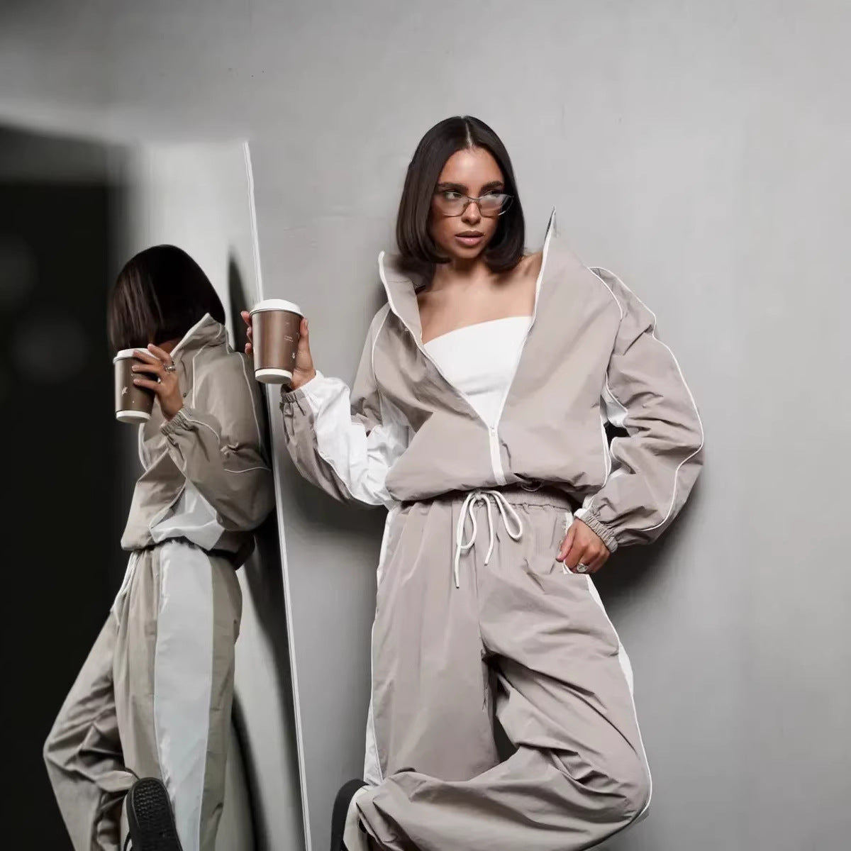 Women's sporty-elegant track set with stand-up collar, zip jacket, and wide side stripe trousers