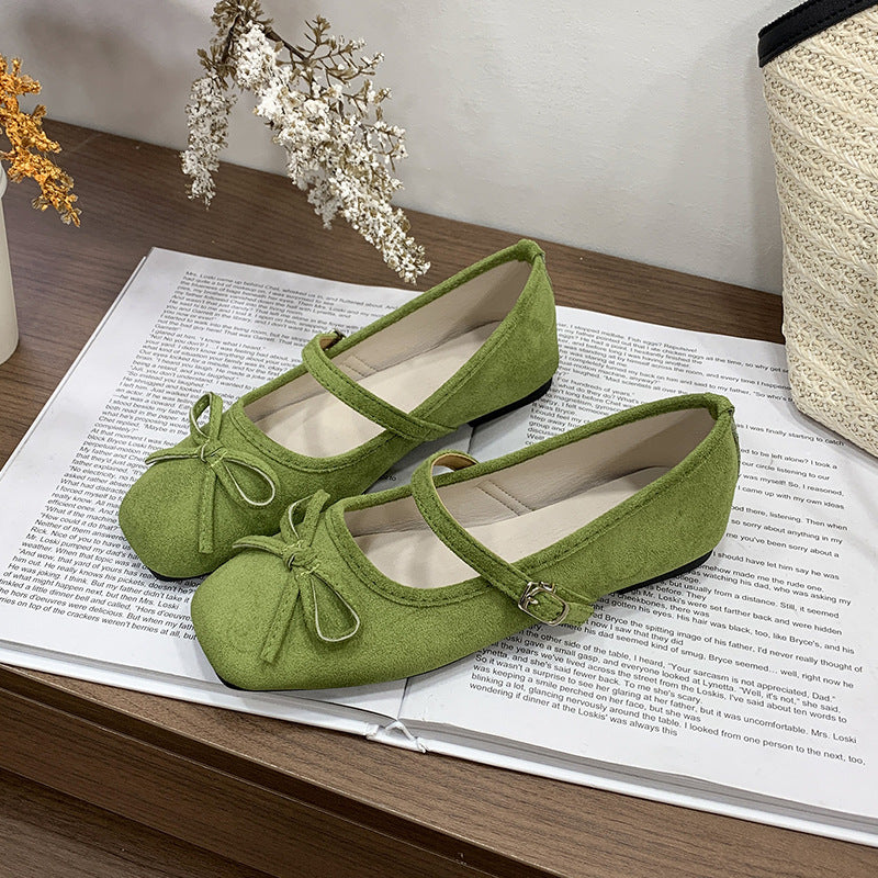 Women's ballet flats with decorative bow accent and comfortable adjustable strap