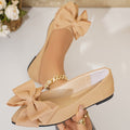 Ladies elegant lace ballerinas with large decorative bow and shimmering upper material