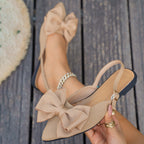 Ladies elegant lace ballerinas with large decorative bow and shimmering upper material