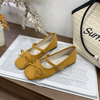 Women's ballet flats with decorative bow accent and comfortable adjustable strap