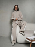 Women's sporty-elegant track set with stand-up collar, zip jacket, and wide side stripe trousers