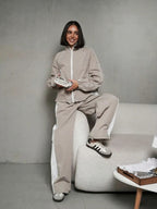 Women's sporty-elegant track set with stand-up collar, zip jacket, and wide side stripe trousers