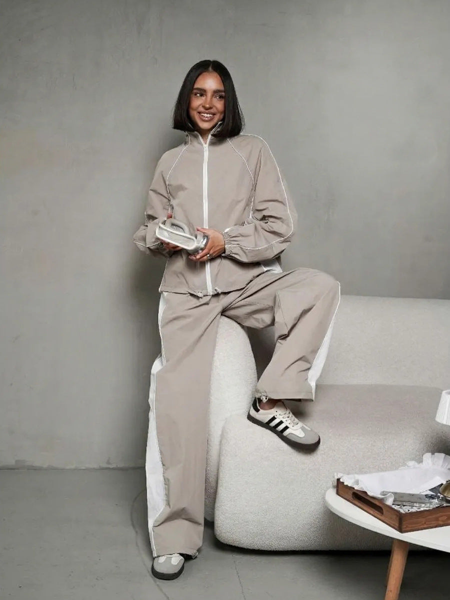 Women's sporty-elegant track set with stand-up collar, zip jacket, and wide side stripe trousers