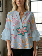 Women's Blouse with Voluminous Ruffle Sleeves and Floral Design