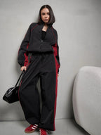 Women's sporty-elegant track set with stand-up collar, zip jacket, and wide side stripe trousers