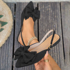 Ladies elegant lace ballerinas with large decorative bow and shimmering upper material